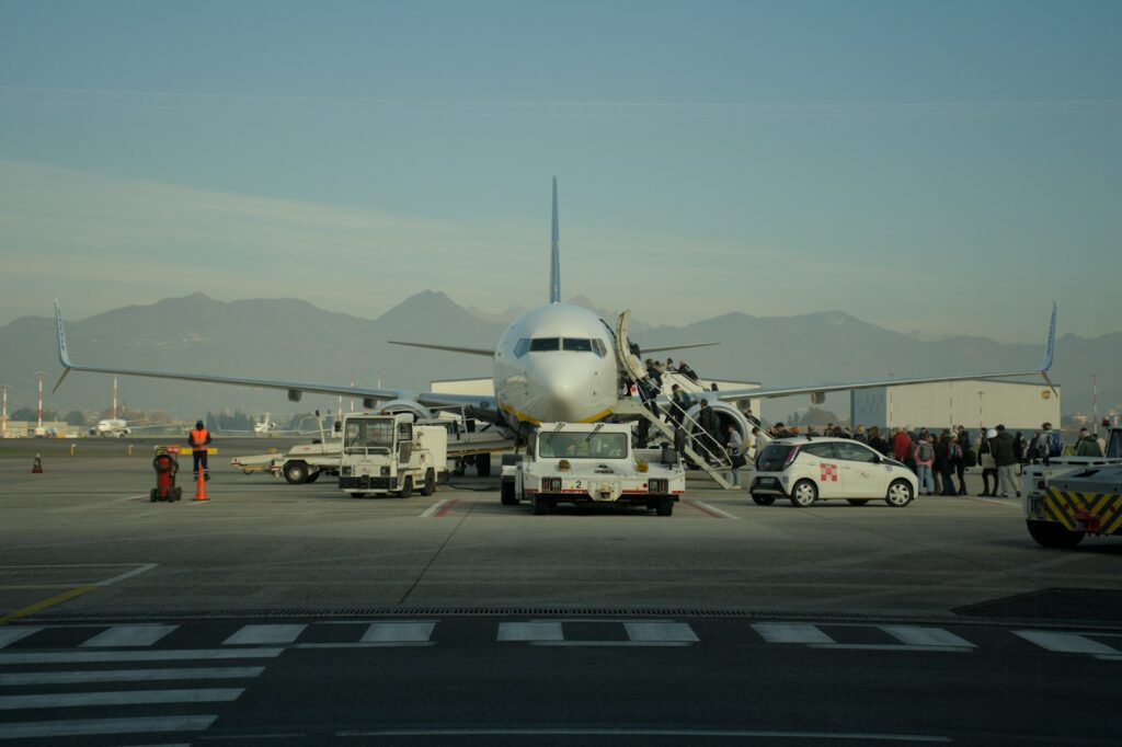 Passengers boarding an airplane at an airport - FastUSTravel Dubai